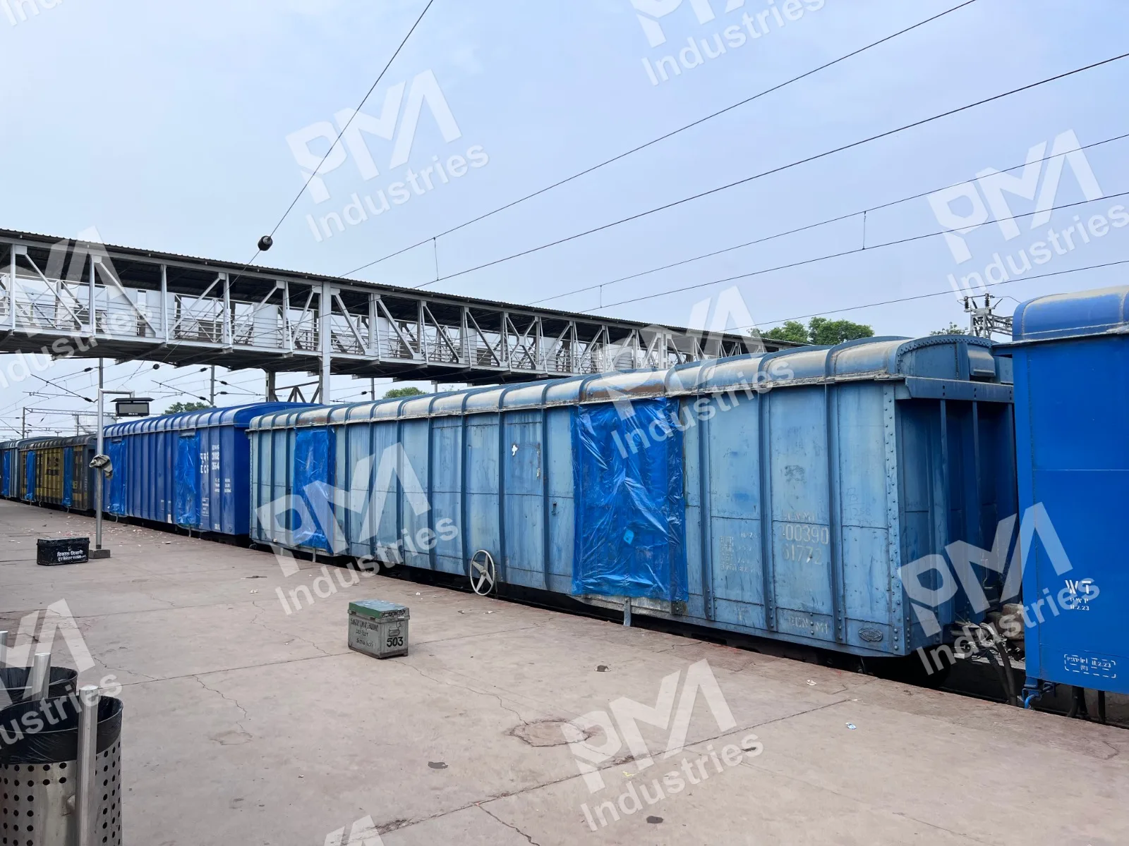 BCN Wagons with Tarpaulin Waterproofing at a Railway Platform